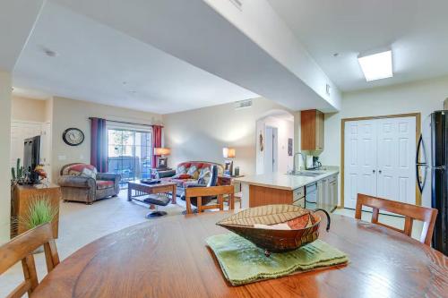 a kitchen and living room with a wooden table at Sunny Mesa Condo with Pool, Patio & Grill in Mesa