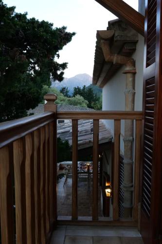 a wooden balcony with a view of a patio at Can Curt Villa in Pollença