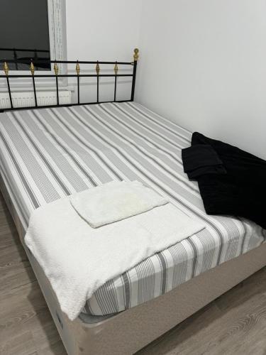 a bed in a room with white and black at Lifford Lane in Birmingham