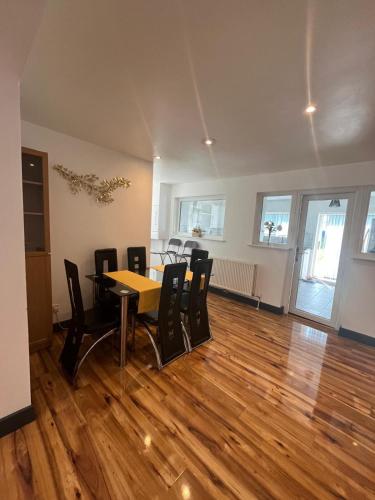 a dining room with a table and chairs at Concord House, 3 bedroom house, 2 baths in Rainham, in Dagenham Dock