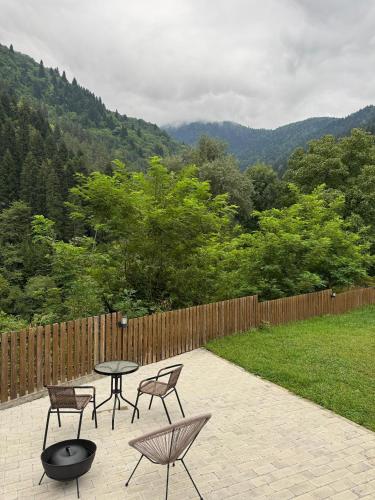 a patio with a table and chairs and a fence at OXYGEN utsera in Utsera