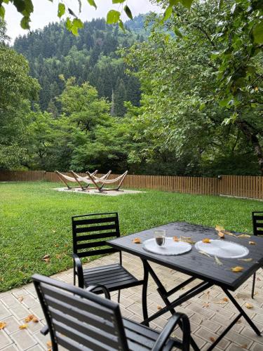 a picnic table with two chairs and a table with a plate at OXYGEN utsera in Utsera