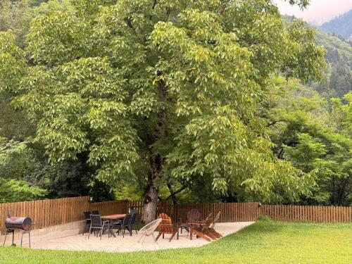a group of tables and chairs under a tree at OXYGEN utsera in Utsera