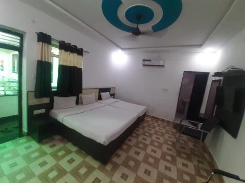 a bedroom with a white bed and a television at Taj 3 Star Hotel Agra Near Taj Mahal in Tājganj
