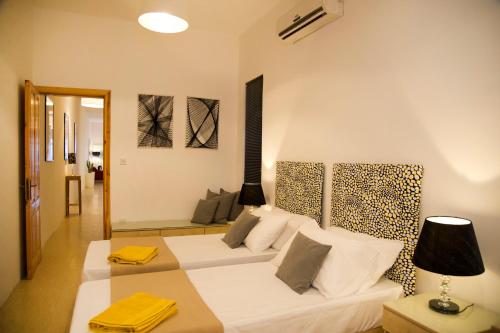 a living room with a white couch and a leopard print wall at Maltese Balcony in St Julian's