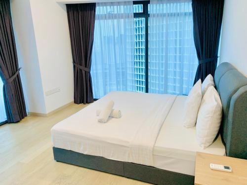 a bedroom with a bed and a large window at Eaton Residences By Classic in Kuala Lumpur