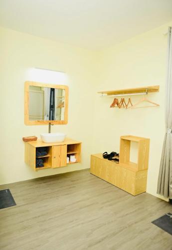 a bathroom with a sink and a mirror on the wall at Homestay The Sunset in Phan Thiet