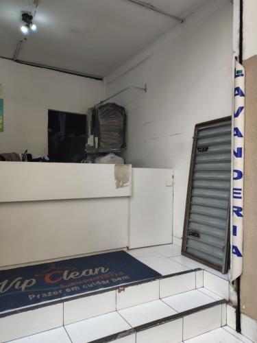 an empty room with a sign on the wall at Hotel Paris in Sao Paulo