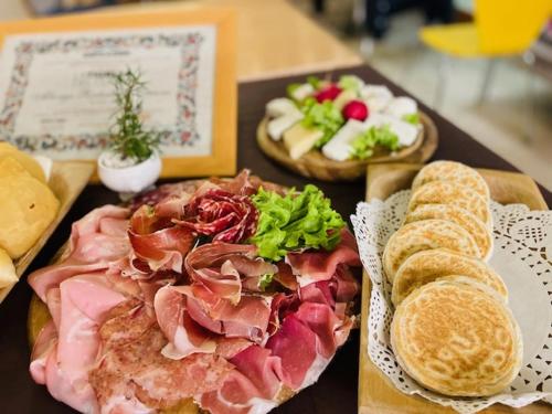 a plate of food with meat and bread on a table at Albergo Ristorante Corsini in Pavullo nel Frignano