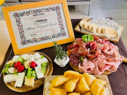 a table with different types of food on it at Albergo Ristorante Corsini in Pavullo nel Frignano