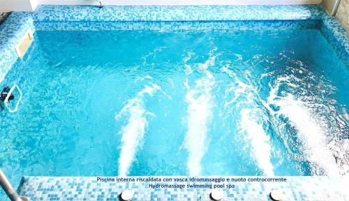 a pool of blue water with a wave at Mansarda Relax Wellness Gym & Spa in Taormina