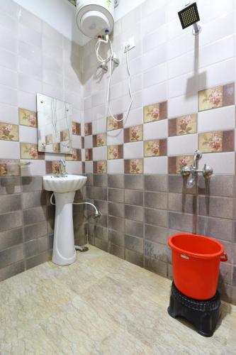 a bathroom with a toilet and a sink and a bucket at Taj 3 Star Hotel Agra Near Taj Mahal in Tājganj
