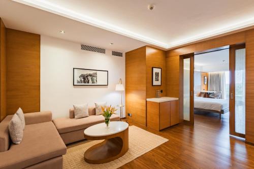 a living room with a couch and a table at Hyatt Pune in Pune