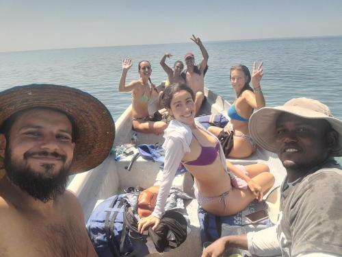 a group of people sitting on a boat in the water at Taida Hostel Rincón del Mar in Rincón