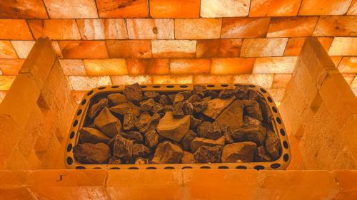 a basket full of rocks in a brick wall at Lynn Times Thanh Thuy Onsen Hot Spring in La Phu