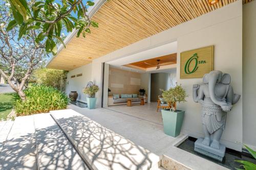 a house with a statue on the side of it at Mia Resort Nha Trang in Nha Trang