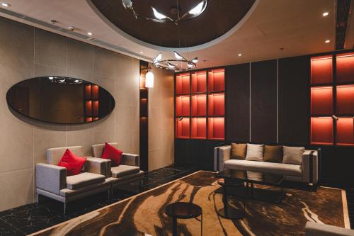 a lobby with two chairs and a table and a mirror at Lynn Times Thanh Thuy Onsen Hot Spring in La Phu