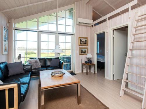 a living room with a couch and a book shelf at 10 person holiday home in Ansager-By Traum in Ansager