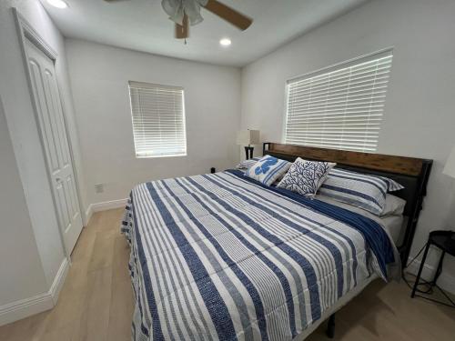 a bedroom with a bed with a blue and white striped blanket at Downtown Cozy 1B-1B #1 in Tampa