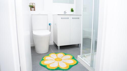 baño con aseo y alfombra de flores en el suelo en Studio New Complete 4 pax, en Madrid