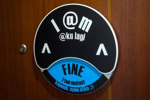 a sign on a door with the word fire on it at MaxOneHotel Tidar Surabaya in Surabaya