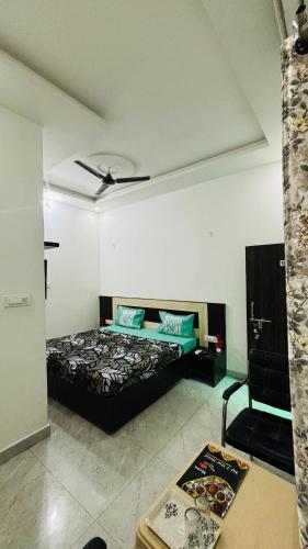 a bedroom with a bed and a ceiling fan at Taj 3 Star Hotel Agra Near Taj Mahal in Tājganj