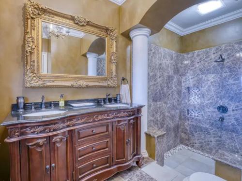 a bathroom with a sink and a shower with a mirror at Luxury Home Villa Pallazzo in Lovran