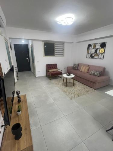 a living room with a couch and a table at Sea View Apartment in Durrës