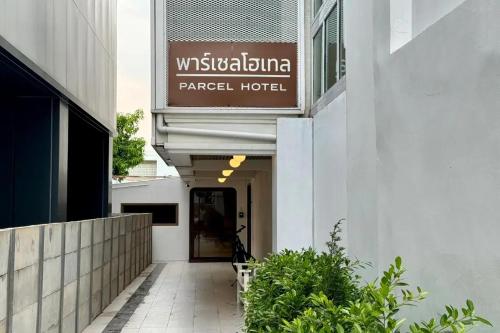 a building with a sign for a hotel at Parcel Hotel Bangkok in Bangkok