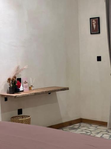 a bedroom with a wooden shelf on the wall at El Campo Mushroom in Nusa Lembongan