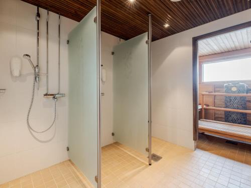 a shower stall in a bathroom with a window at Santa's Hotel Santa Claus in Rovaniemi