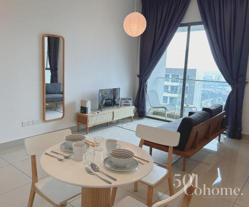 a living room with a table and chairs and a couch at Cyberjaya - Netflix - Disney - Wifi in Cyberjaya