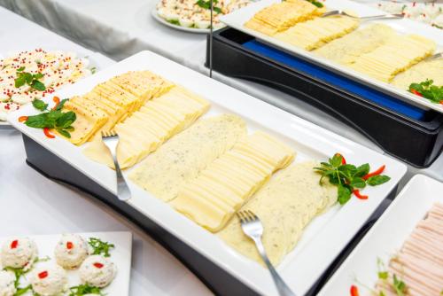 a buffet of cheese and crackers on a white plate at Hotel Echo in Cedzyna