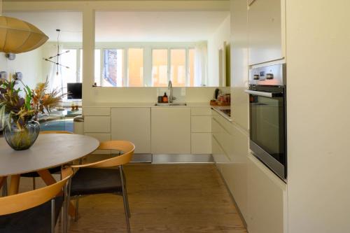 a kitchen with a table and a dining room at Best Stay Copenhagen Apartment 1506 in Copenhagen