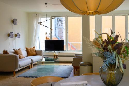 a living room with a couch and a table at Best Stay Copenhagen Apartment 1506 in Copenhagen