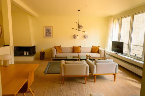 a living room with a couch and a table at Best Stay Copenhagen Apartment 1506 in Copenhagen