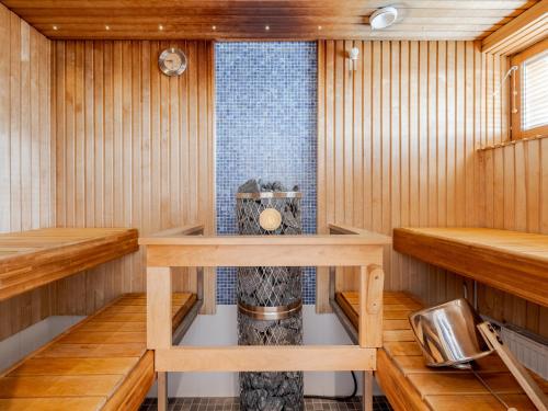 a sauna with wooden walls and wooden shelves at Santa's Hotel Santa Claus in Rovaniemi