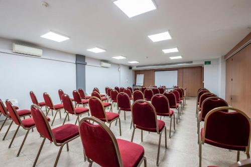 an empty room with red chairs and a whiteboard at Travelodge Alicante Puerto in Alicante