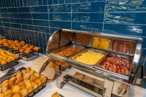 a buffet filled with lots of different types of food at Travelodge Alicante Puerto in Alicante