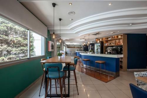 a kitchen with a wooden table and blue walls at Travelodge Alicante Puerto in Alicante