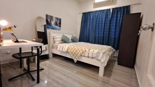 a bedroom with a bed and a desk and a desk at Teratak Healing in Batu Caves