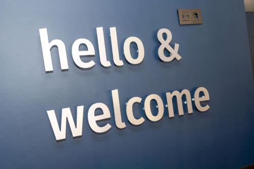 a sign that says hello and welcome on a wall at Travelodge Alicante Puerto in Alicante