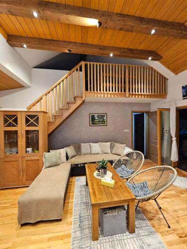 a living room with a couch and a table at Vikendica Šehić in Zavidovići