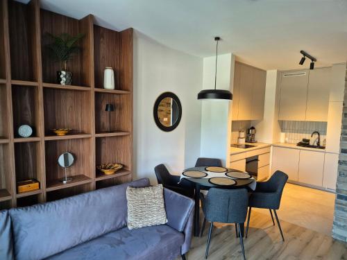 a living room with a couch and a table at Czarna Perła in Hel