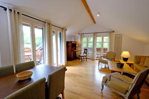 a living room with a table and chairs at Hotel Gut Klostermühle natur resort & medical spa in Alt Madlitz