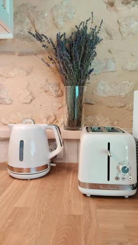 two toasters sitting on top of a wooden floor at Gîte du Moulin de Maître Pierre in Payrignac