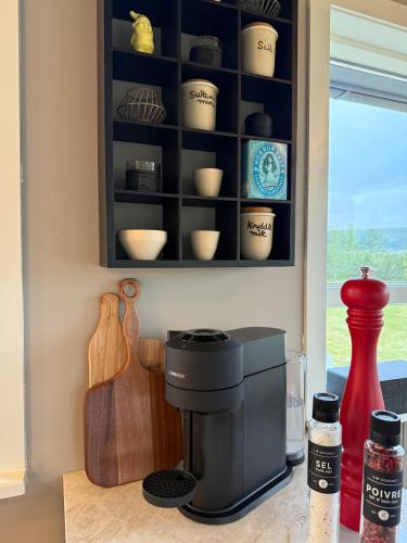 a kitchen with a coffee maker on a counter at Luxurious Cabin with Hot tub in Stóri-Ás
