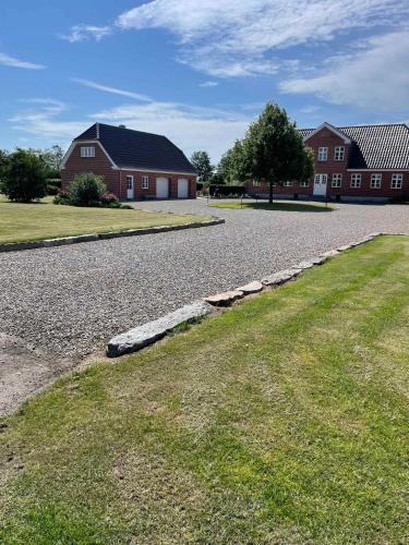 a cobblestone road in front of a house at Luxury Country House In Nature With Wellness in Haderslev