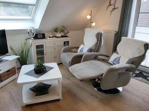 a living room with two chairs and a table at Mellum in Norden
