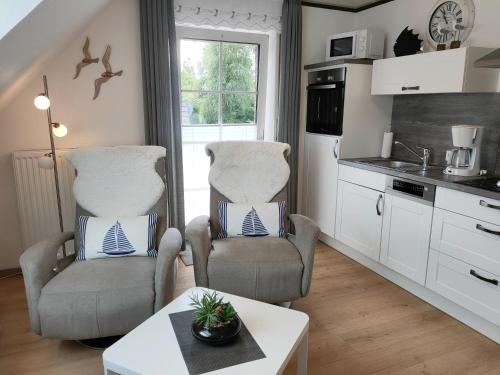 a kitchen with two chairs and a table at Mellum in Norden